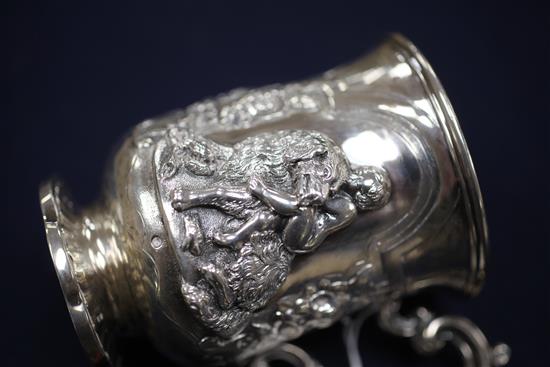 A Victorian silver christening mug embossed with a child and seated dog, 7 oz.